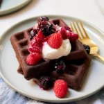Delicious cake mix waffles served with syrup and berries.