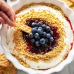 Delicious cheesecake dip served with fresh fruit and graham crackers