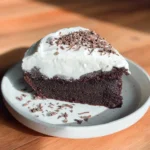 Delicious chocolate pumpkin cake topped with chocolate frosting on a rustic plate
