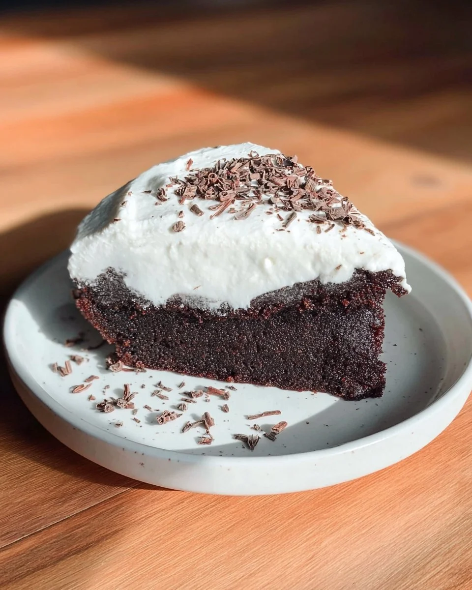 Delicious chocolate pumpkin cake topped with chocolate frosting on a rustic plate