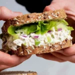 Delicious cottage cheese chicken salad in a bowl garnished with herbs.
