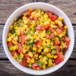 Bowl of colorful corn salsa inspired by Chipotle's recipe, ready to serve.