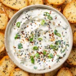 Delicious homemade Everything Bagel Dip served in a bowl with bagel chips
