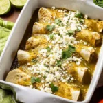 Homemade green enchilada sauce served in a bowl with fresh herbs.