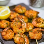 Delicious grilled shrimp served with dipping sauce and fresh herbs