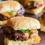 Delicious jalapeno cheddar sliders served on a platter with toppings.