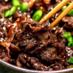 Deliciously marinated Beef Bulgogi served on a platter with vegetables and rice.