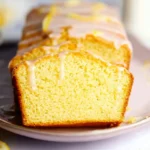Delicious Lemon Yogurt Loaf Cake with a light frosting and lemon zest garnish.