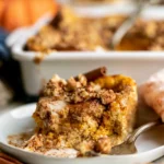 Pumpkin French Toast Casserole topped with syrup and whipped cream
