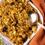 Homemade pumpkin seed granola in a bowl with nuts and dried fruits