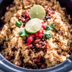A bowl of Slow Cooker Rice and Beans served with fresh herbs and spices