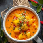 Bowl of Thai Pumpkin Red Curry garnished with fresh herbs and served