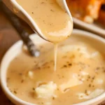 Delicious homemade Turkey Dripping Gravy served over turkey.