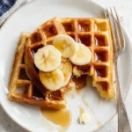 Delicious homemade waffles for one on a plate with syrup and berries