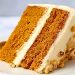 Whole orange cake garnished with fresh slices of orange and mint leaves
