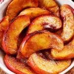 Baked apple slices with no added sugar, arranged on a plate.