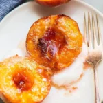 Delicious baked peaches topped with cinnamon and sugar.