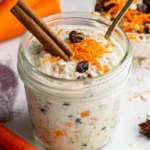 Bowl of carrot cake overnight oats topped with nuts and spices