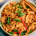Delicious Drunken Noodles Pad Kee Mao served with fresh vegetables and spices