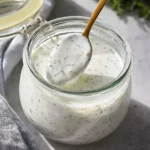 Bowl of easy homemade ranch dressing with fresh herbs and spices.