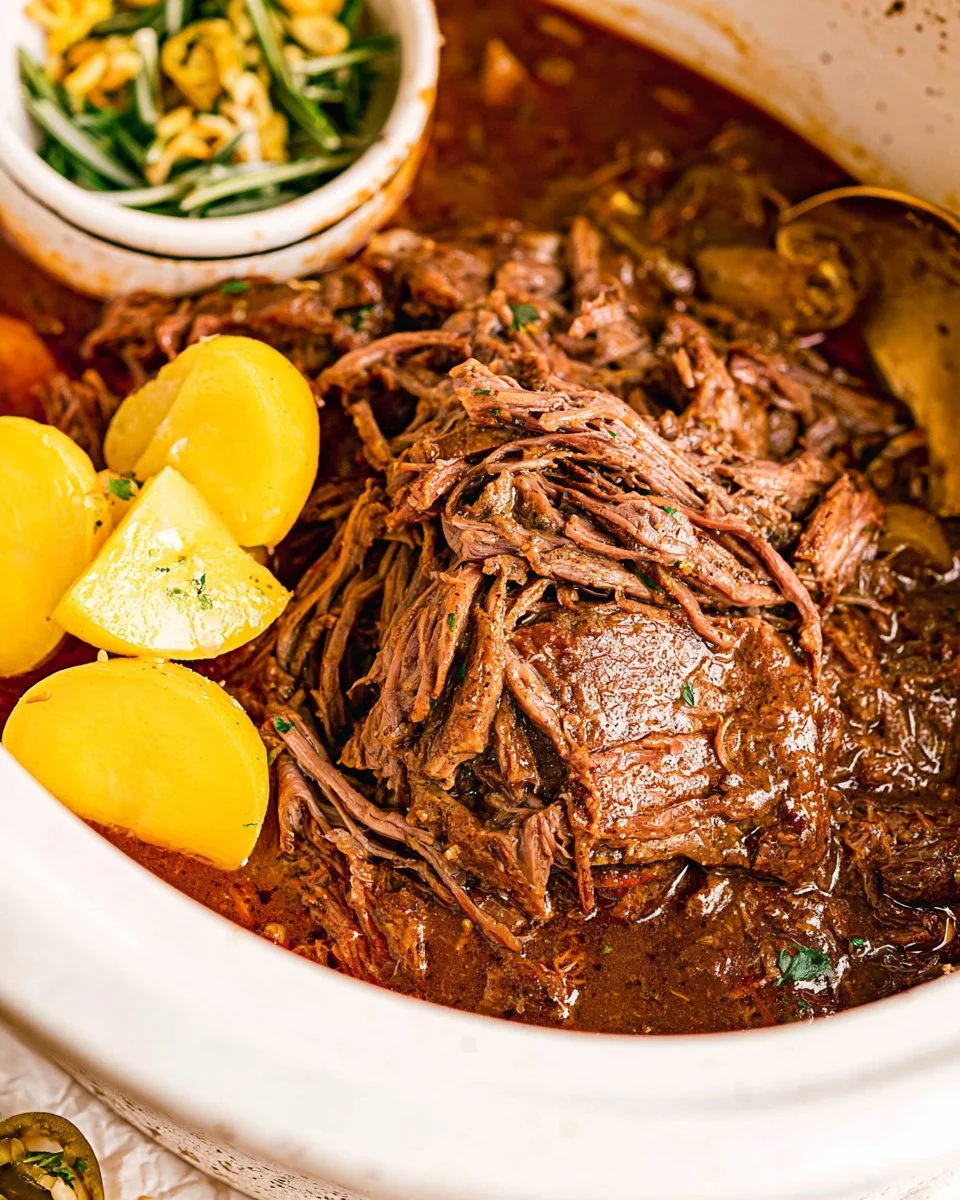 Delicious Mississippi Roast made in a Crock Pot, featuring tender beef and savory seasonings.
