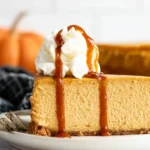 Delicious no bake pumpkin cheesecake topped with whipped cream and spices
